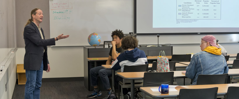 Instructor giving lecture to students in classroom