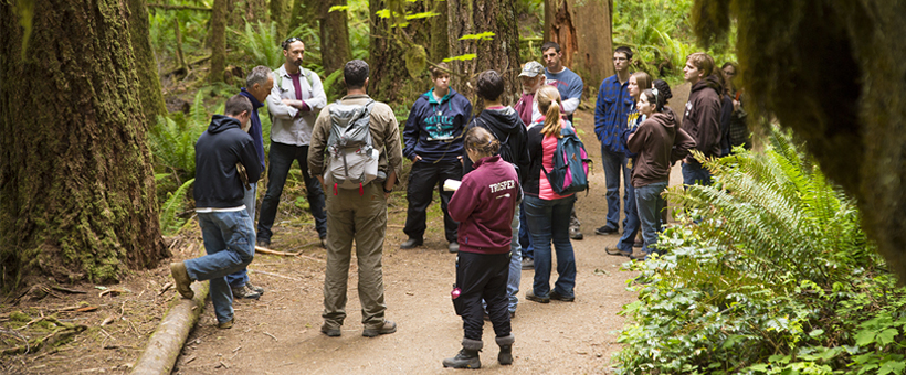 Class taking place in a forest